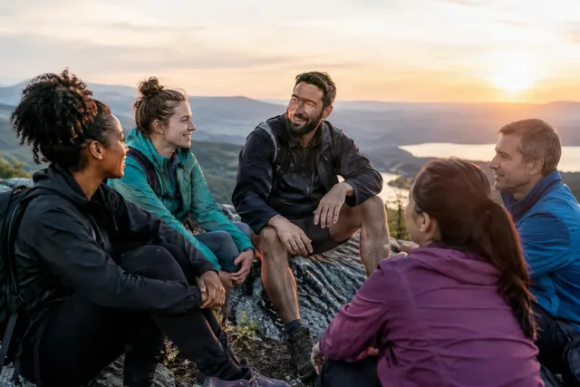 Hikers Sharing Encouragement at Sunset