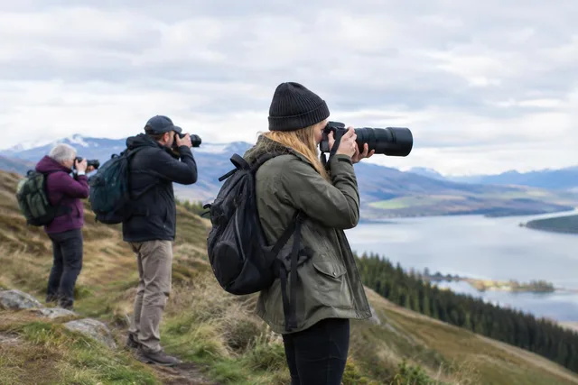 Hikers Photographing Mountain Lake