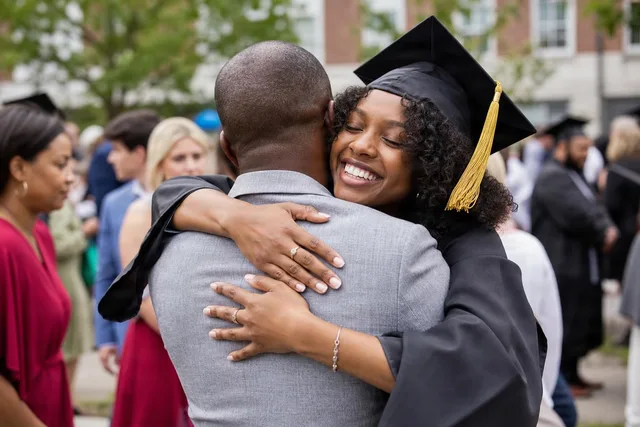 Graduate Hugging Family Outdoors