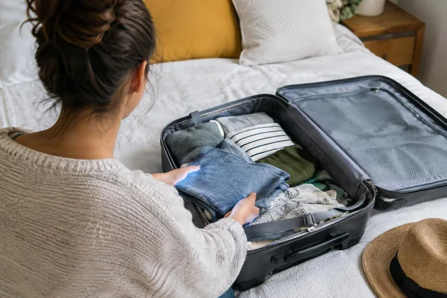 Packing Clothes Into Suitcase