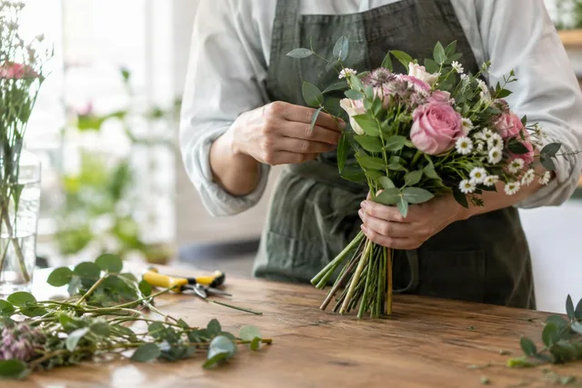 Hands Arranging Fresh Flower Bouquet