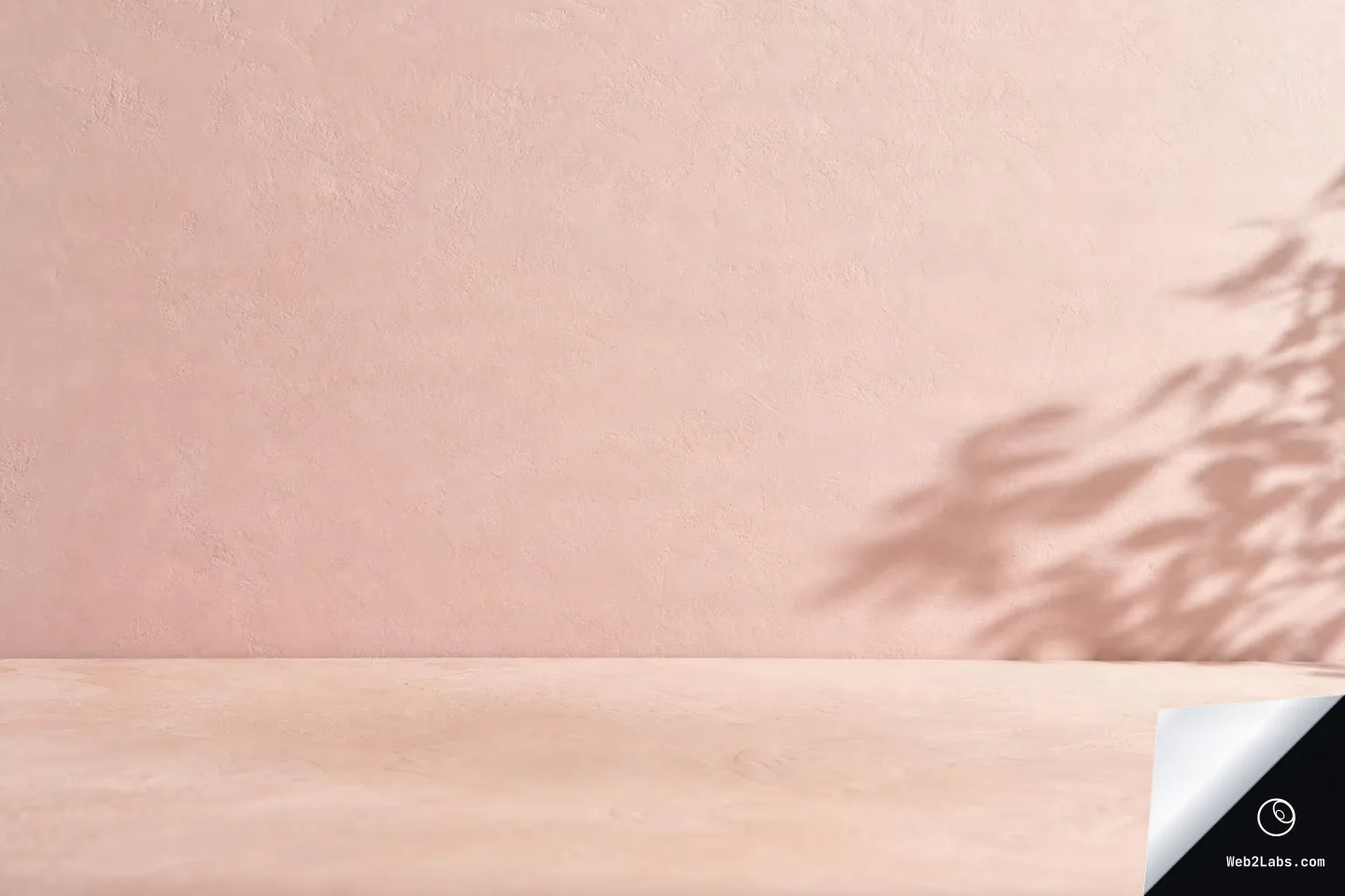 Minimal blush pink textured plaster wall and pale tabletop with soft plant shadows on the right side, leaving wide empty space for copy.