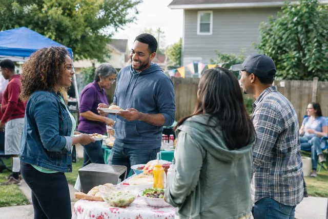 Neighbors Chatting at Backyard Potluck