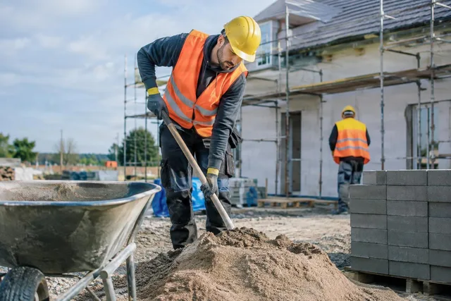 Construction Worker Mixing Sand