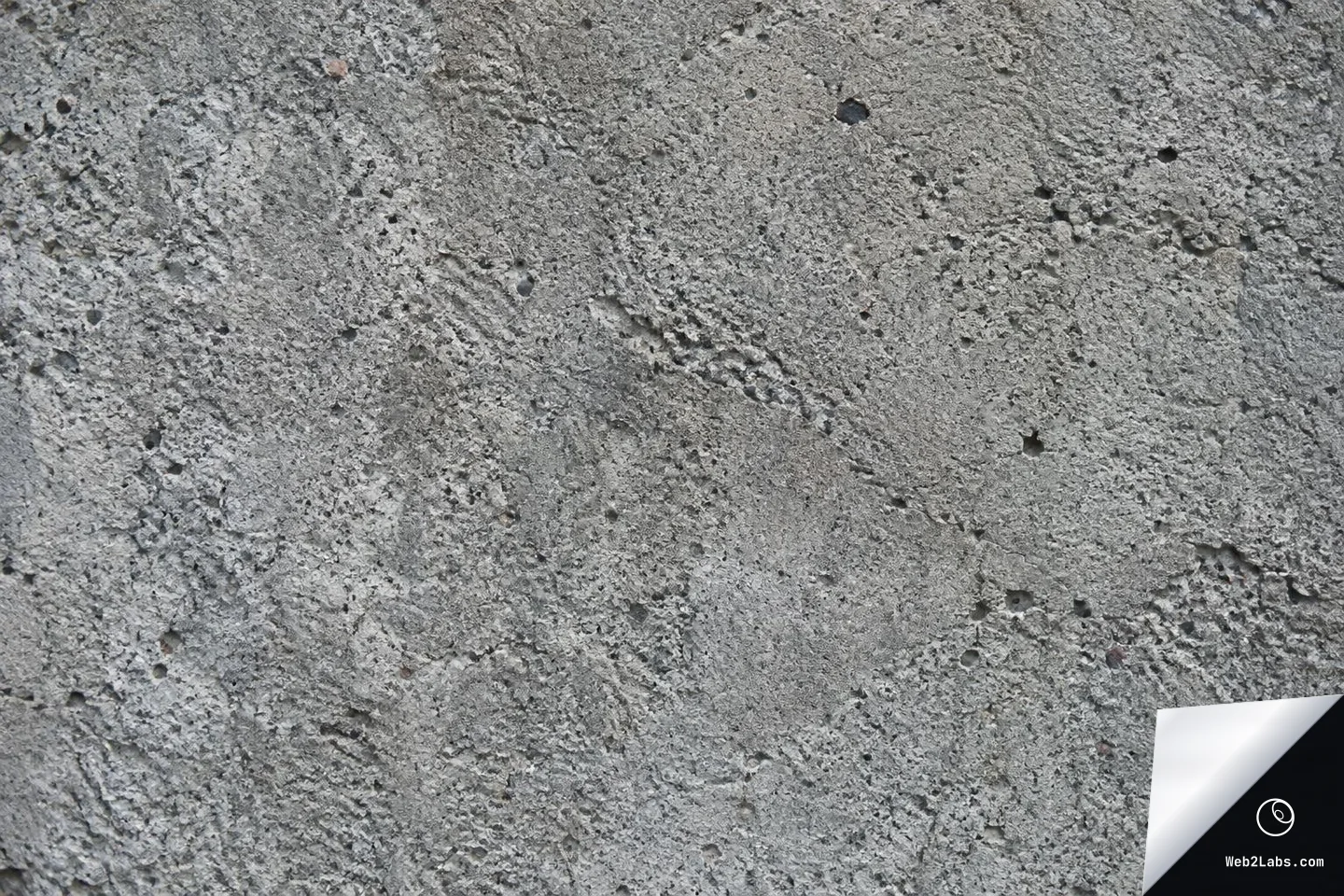 Close-up of a rough gray concrete surface with small pits, pores, and uneven texture across the frame.