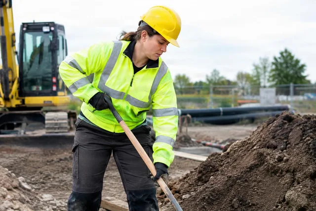 Construction Worker Shoveling Soil