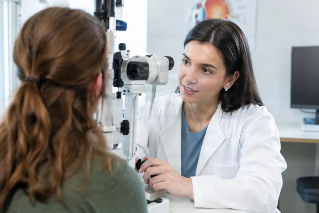 Optometrist Exam Over Patient Shoulder