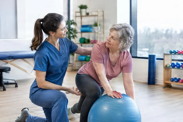 Physiotherapist Assisting Senior Exercise