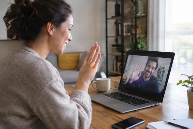 Woman Waving During Video Call