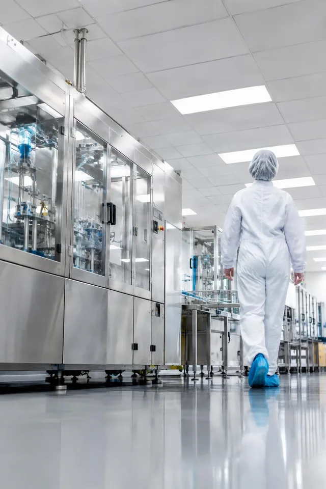 Cleanroom Technician in Factory Aisle