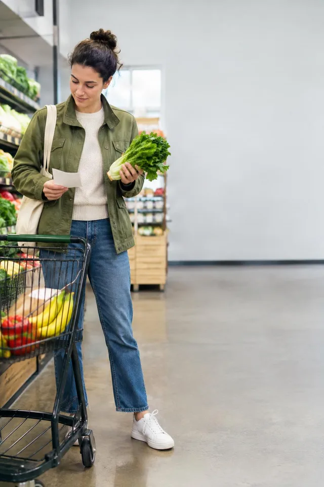 Checking Grocery List in Produce Aisle
