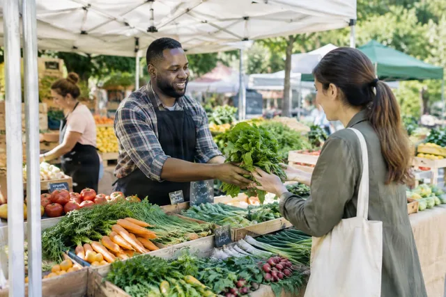 Farmers Market Seller Handing Greens