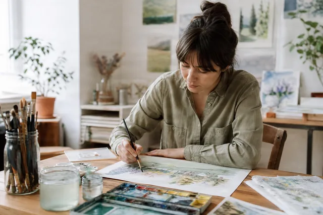 Artist Painting Watercolor at Desk