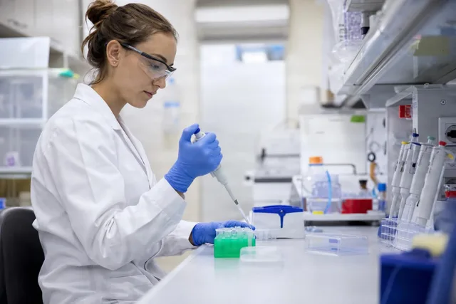 Lab Technician Pipetting Samples