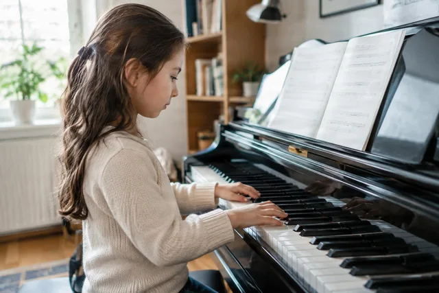 Child Practicing Piano at Home