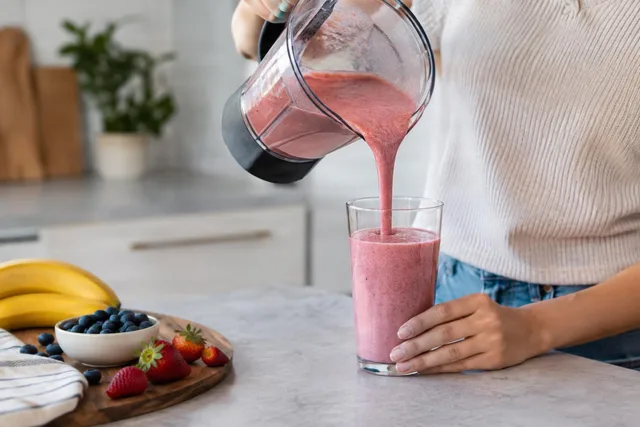 Pouring Berry Smoothie Into Glass