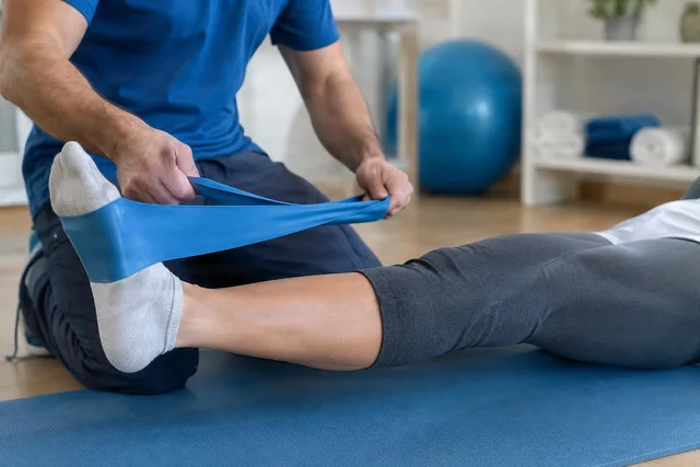 Physiotherapist Assisting Band Stretch