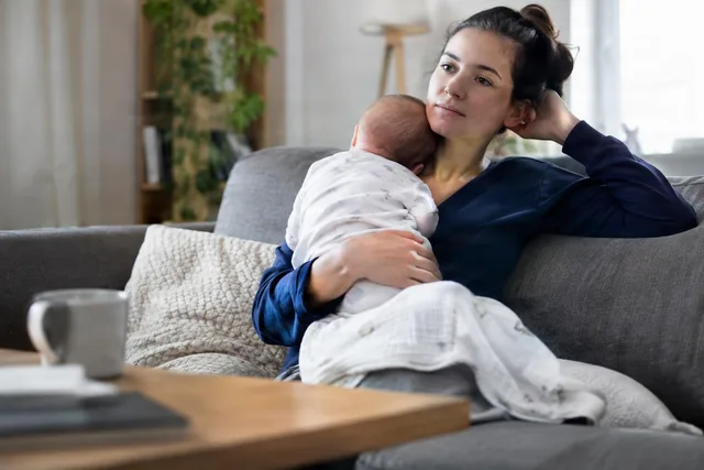 Tired Mom Holding Newborn